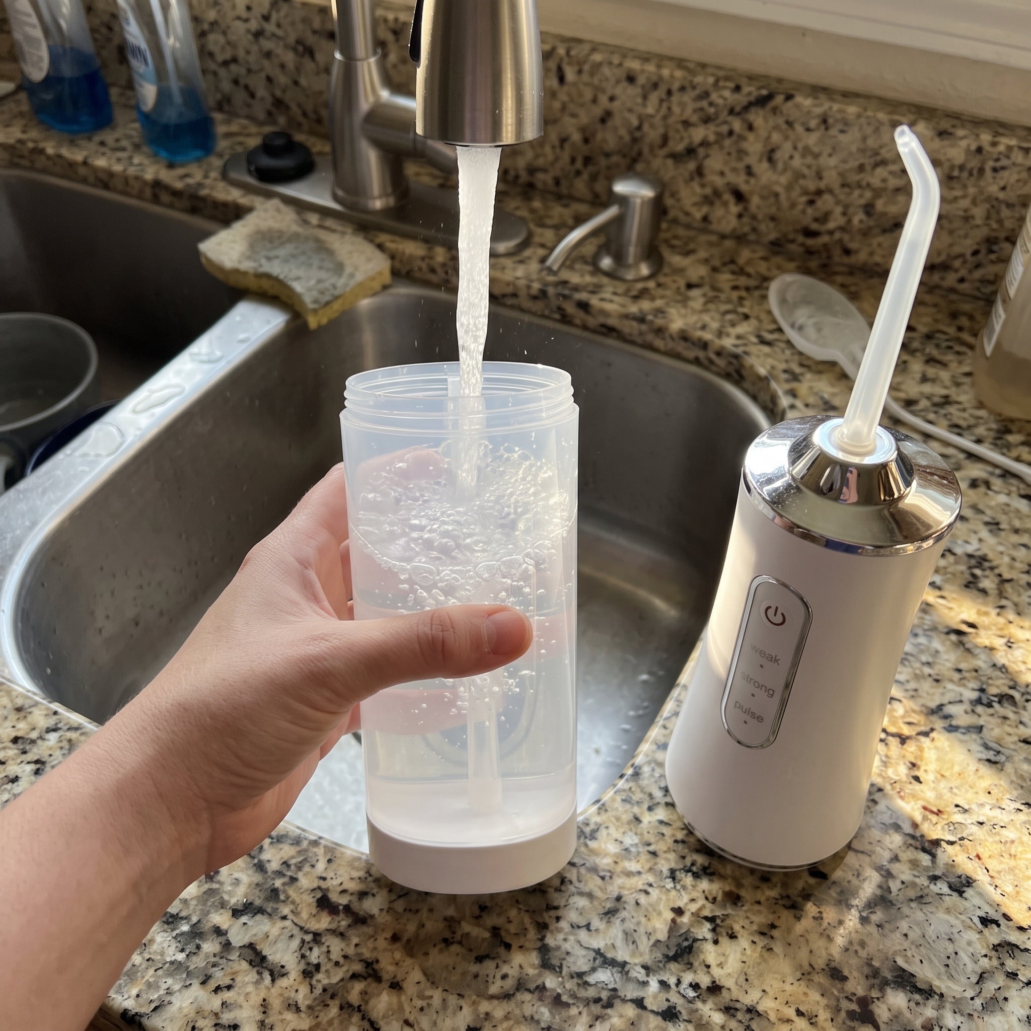 White Freshflow being refilled at a kitchen tap